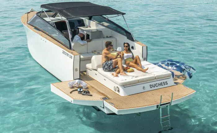 A couple unwinds on the deck of "Duchess" as it glides through the clear blue waters, while a skilled captain from Rewind Dubrovnik's Boats expertly navigates their journey.