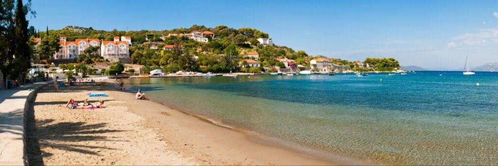 Blue skies and sandy beaches on Kolocep Beach on Kolocep Island