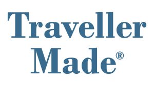 The image shows the words "Traveller Made" in blue serif font with a registered trademark symbol next to "Made" on a white background.